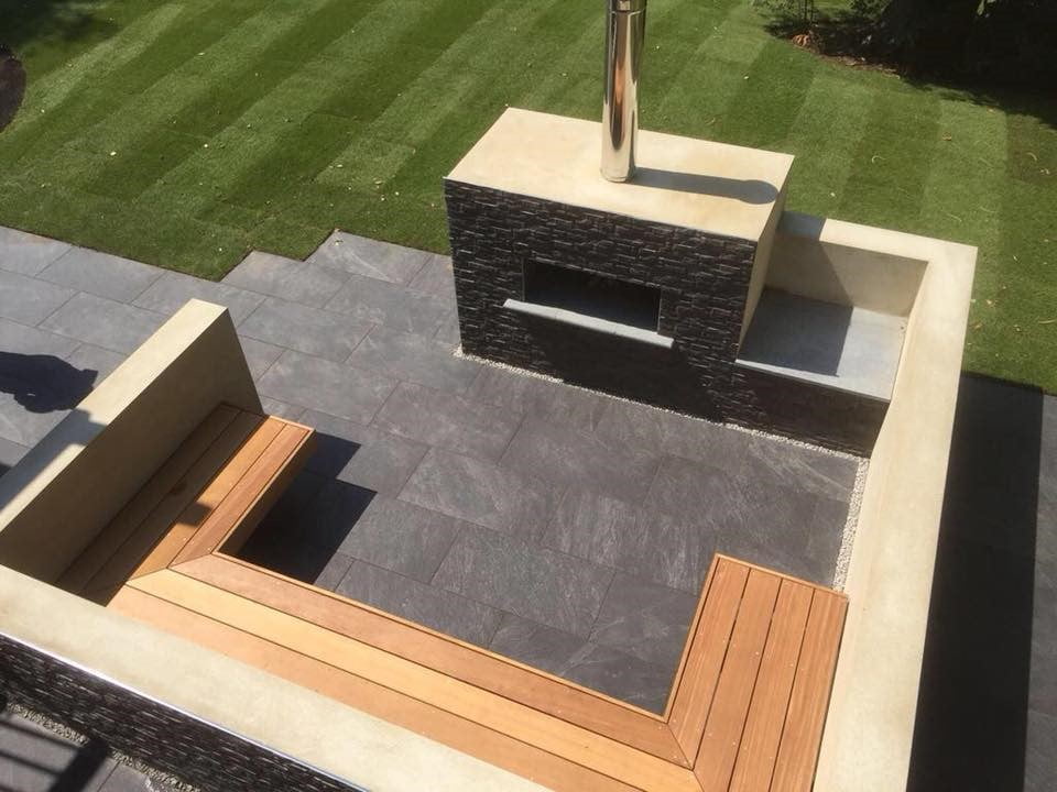 Hardwood bench with outdoor fireplace clad