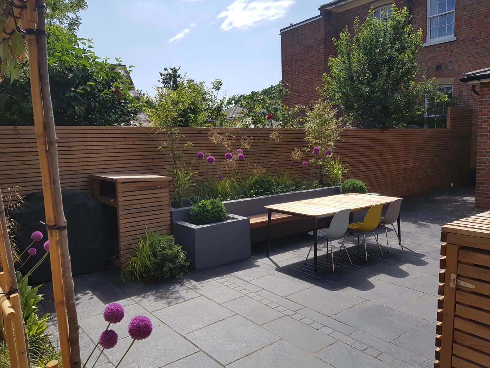 Hardwood bench seat with black limestone patio