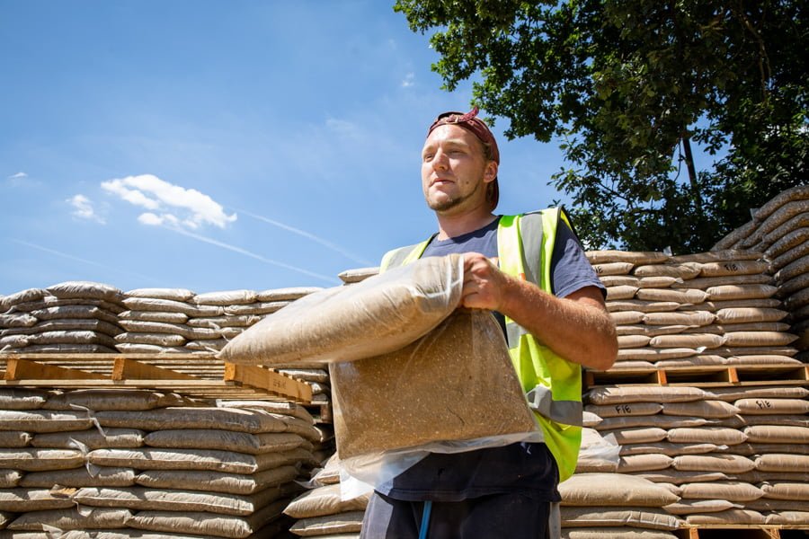 Yard assistant carrying aggregates Yard assistant carrying aggregates